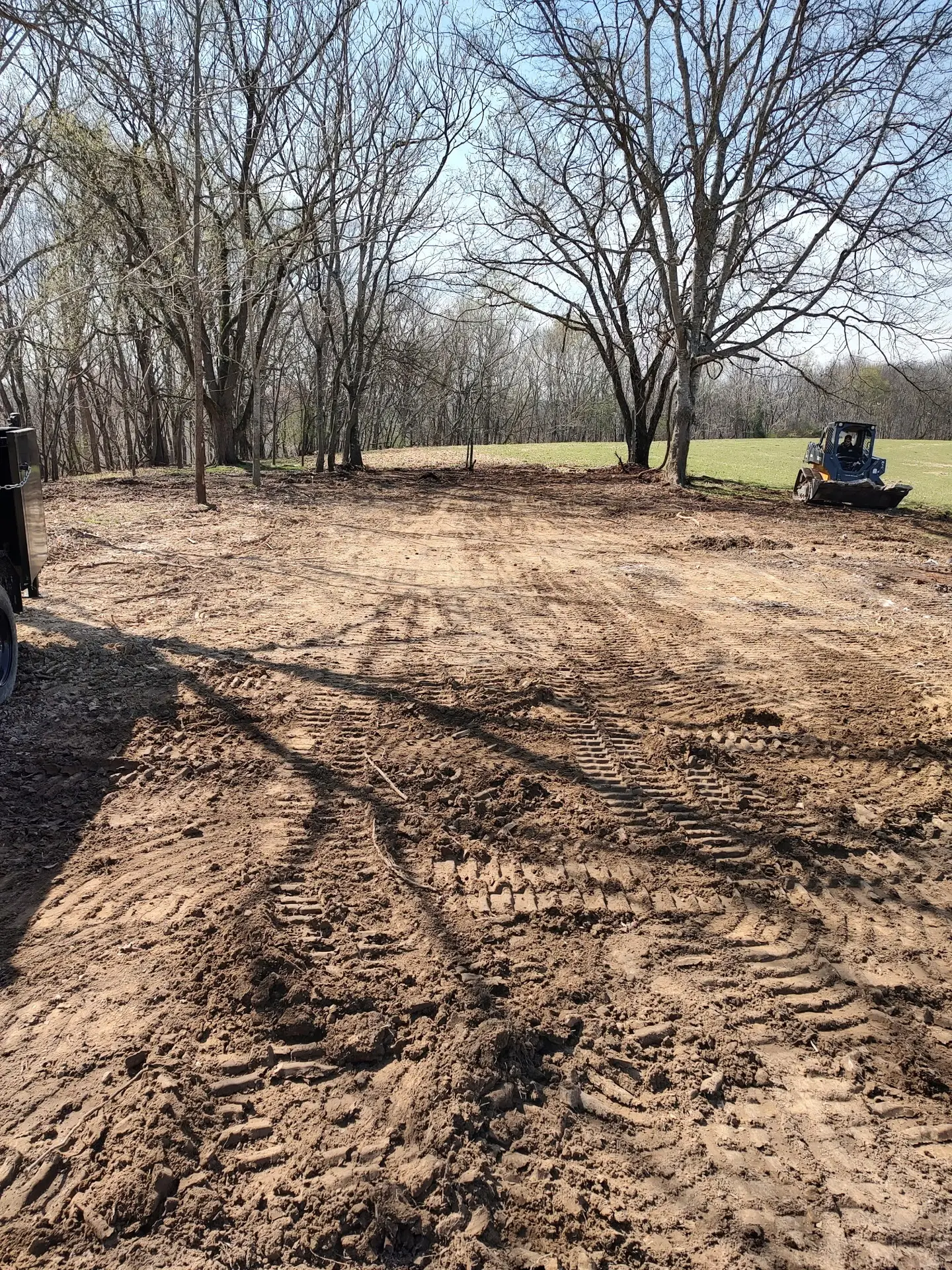 Forestry mulching and land clearing equipment on a wooded property